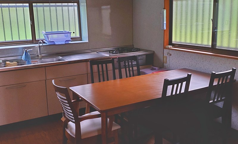 The kitchen and dining room at Kichi Itako, with a table seating six